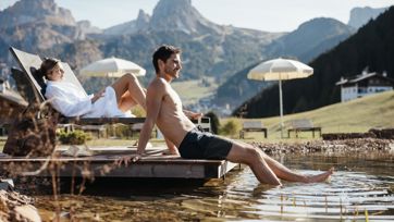 Two people a relaxing at our swimming pond