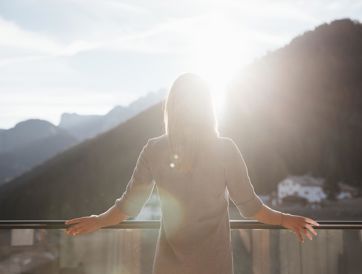 A woman is standing on the balcony