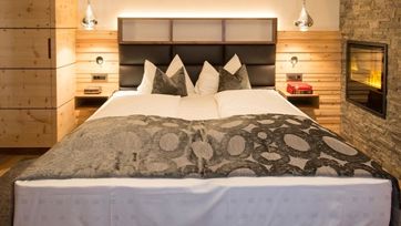 The bedroom with a king size bed and a fireplacea