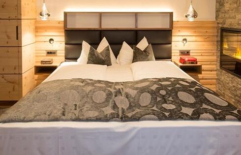 The bedroom with a king size bed and a fireplacea