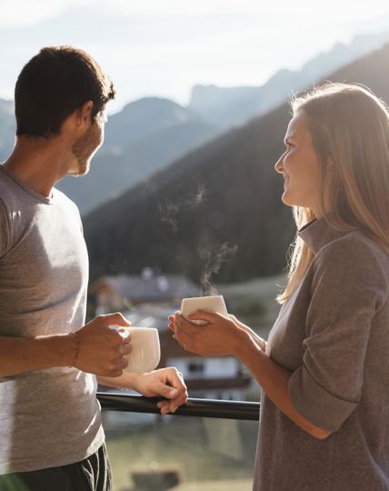 A man and a woman are drinking a cup of tea