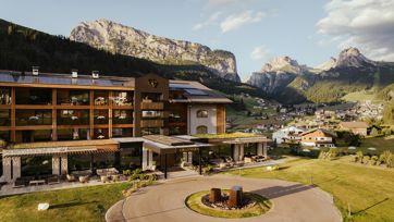 Our hotel in Val Gardena with view of Sassolungo and valley at sunset